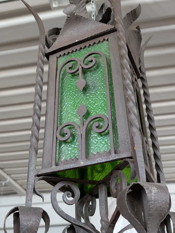 Suspended lantern made of wrought iron and green blown glass