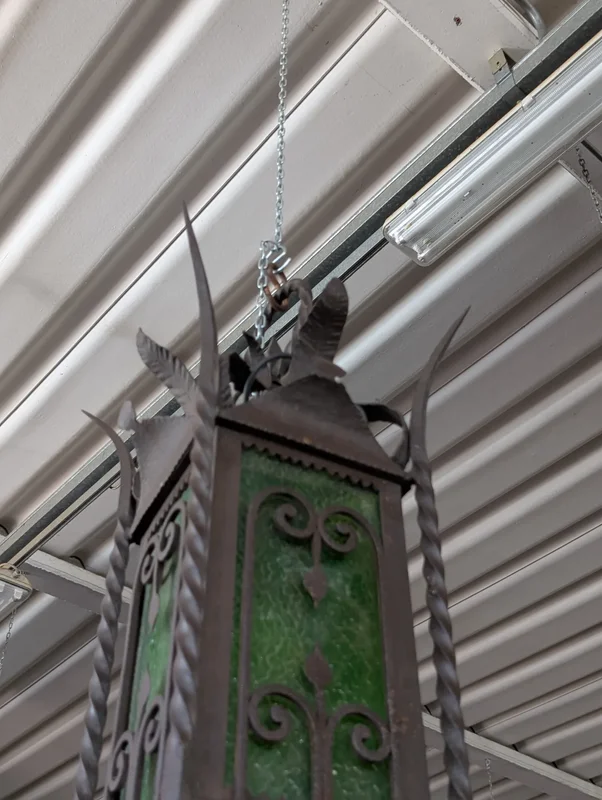 Suspended lantern made of wrought iron and green blown glass