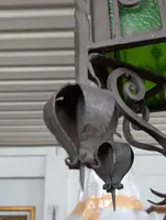 Suspended lantern made of wrought iron and green blown glass
