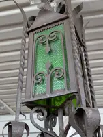 Suspended lantern made of wrought iron and green blown glass