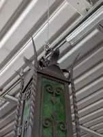 Suspended lantern made of wrought iron and green blown glass