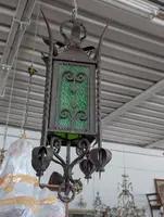 Suspended lantern made of wrought iron and green blown glass