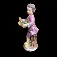 Meissen porcelain figurine,baby with flower basket.