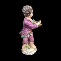 Meissen porcelain figurine,baby with flower basket.