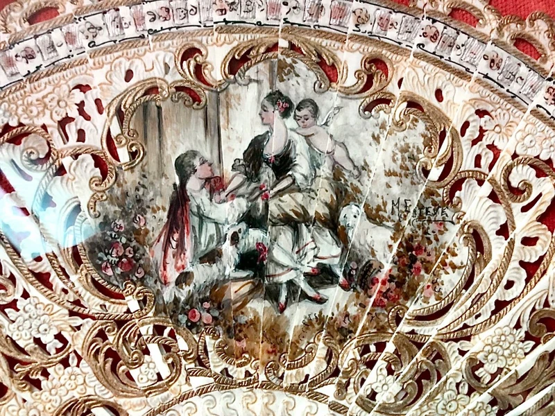 Fan with pierced bone slats with gold highlights and painted gallant scene.France