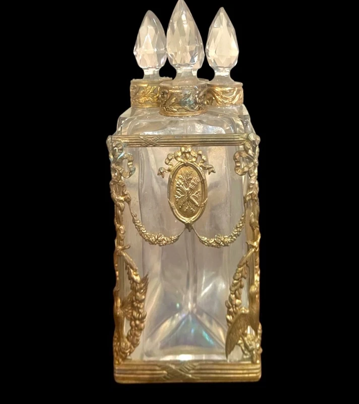 Brass and crystal perfume holder with four small bottles with triangular cross-section.
