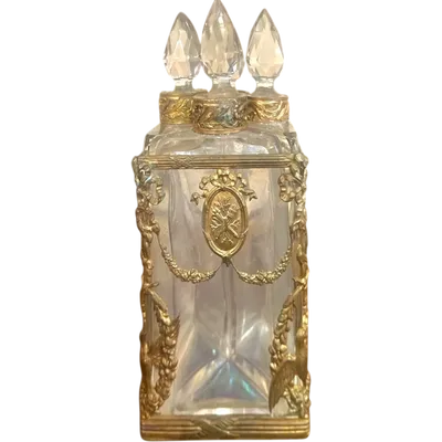 Brass and crystal perfume holder with four small bottles with triangular cross-section.