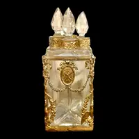 Brass and crystal perfume holder with four small bottles with triangular cross-section.