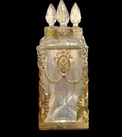 Brass and crystal perfume holder with four small bottles with triangular cross-section.