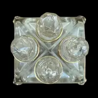 Brass and crystal perfume holder with four small bottles with triangular cross-section.