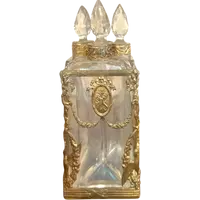 Brass and crystal perfume holder with four small bottles with triangular cross-section.