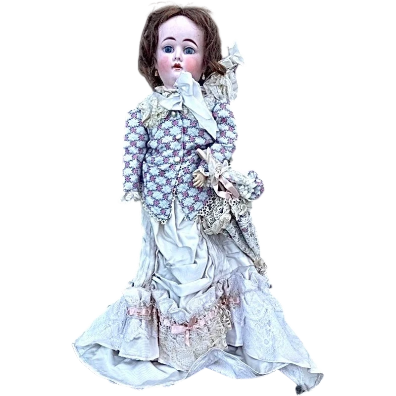 Doll with bisque head and paper mache body.Finely embroidered dress.