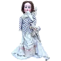 Doll with bisque head and paper mache body.Finely embroidered dress.