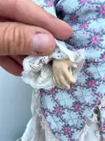 Doll with bisque head and paper mache body.Finely embroidered dress.