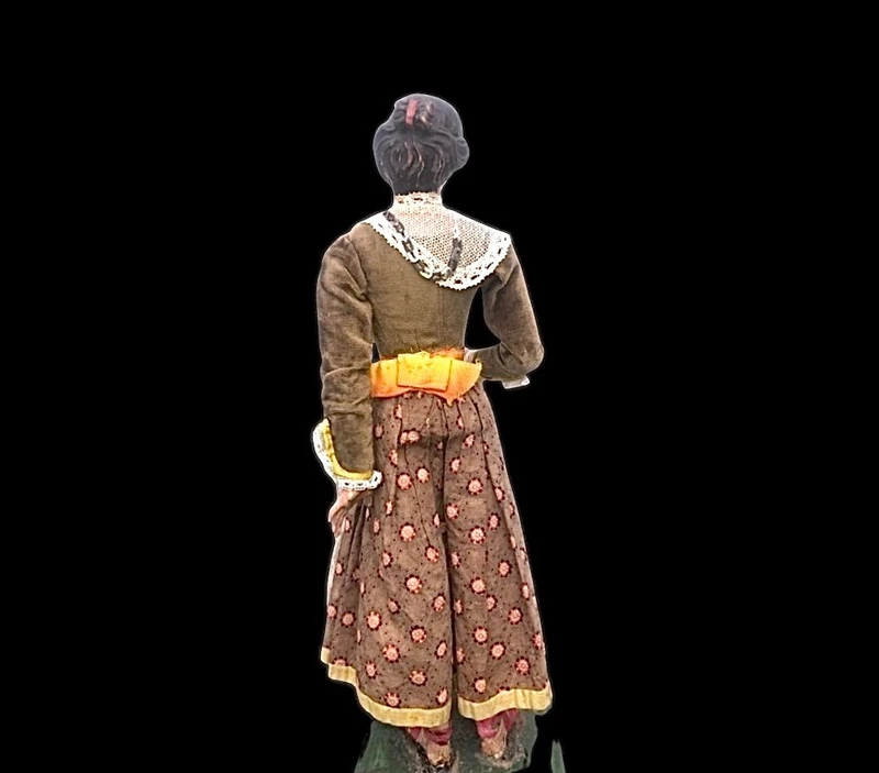 Painted wooden nativity scene figurine depicting peasant woman.Genoa.