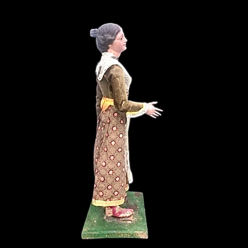 Painted wooden nativity scene figurine depicting peasant woman.Genoa.