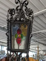 Suspended lantern made of wrought iron and leaded colored glass