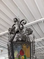 Suspended lantern made of wrought iron and leaded colored glass
