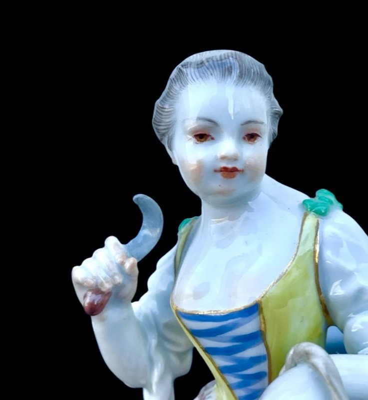 Porcelain sculpture depicting a peasant woman with a sickle. Meissen
