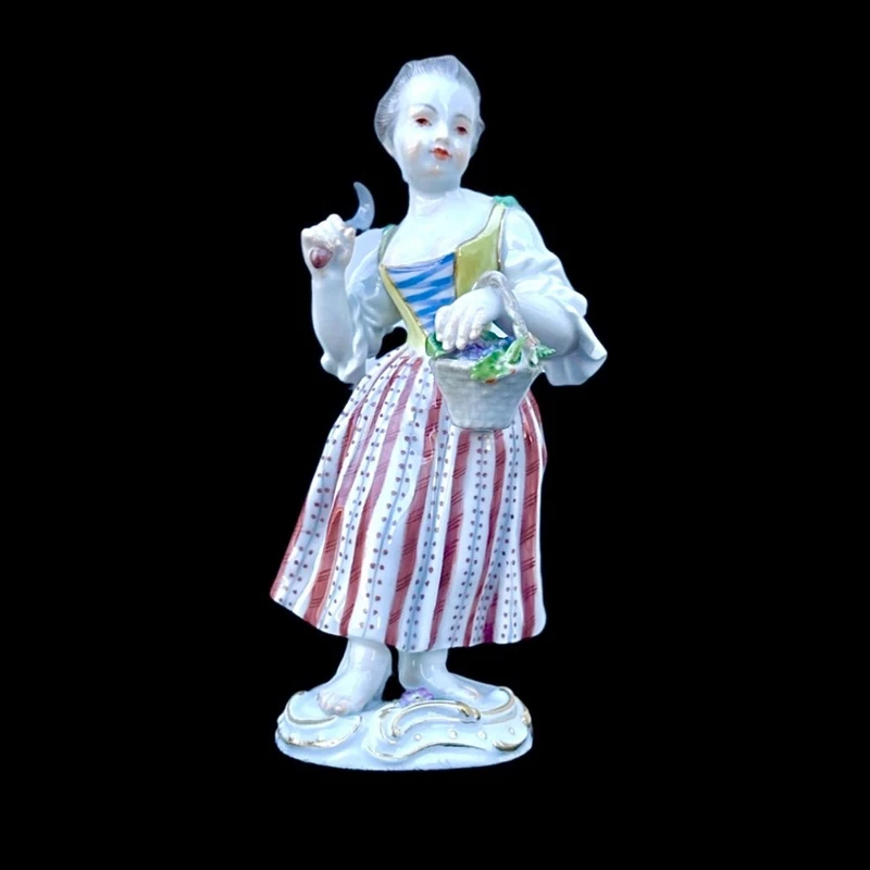 Porcelain sculpture depicting a peasant woman with a sickle. Meissen