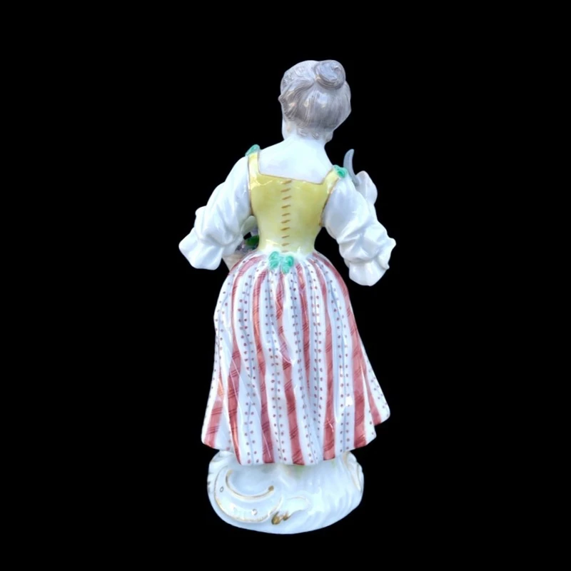 Porcelain sculpture depicting a peasant woman with a sickle. Meissen