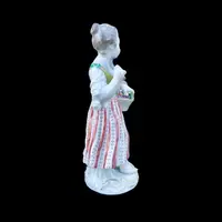 Porcelain sculpture depicting a peasant woman with a sickle. Meissen