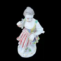 Porcelain sculpture depicting a peasant woman with a sickle. Meissen