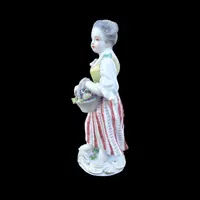 Porcelain sculpture depicting a peasant woman with a sickle. Meissen