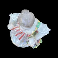 Porcelain sculpture depicting a peasant woman with a sickle. Meissen