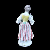 Porcelain sculpture depicting a peasant woman with a sickle. Meissen