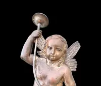 A pair of silver-plated copper wall sconces featuring angels.