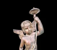 A pair of silver-plated copper wall sconces featuring angels.
