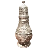 Silver sugar shaker featuring animal motifs, seed beads, and a medallion with engraved initials.