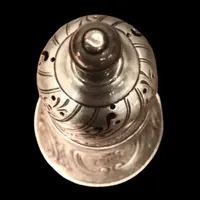 Silver sugar shaker featuring animal motifs, seed beads, and a medallion with engraved initials.