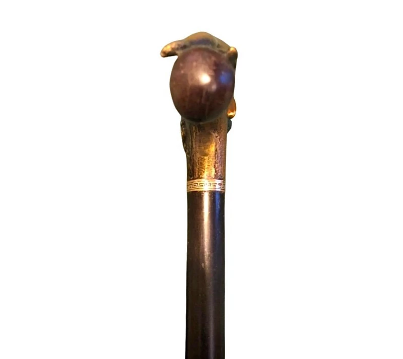 A walking stick with an erotic motif, featuring a bronze handle depicting a reclining nude woman.