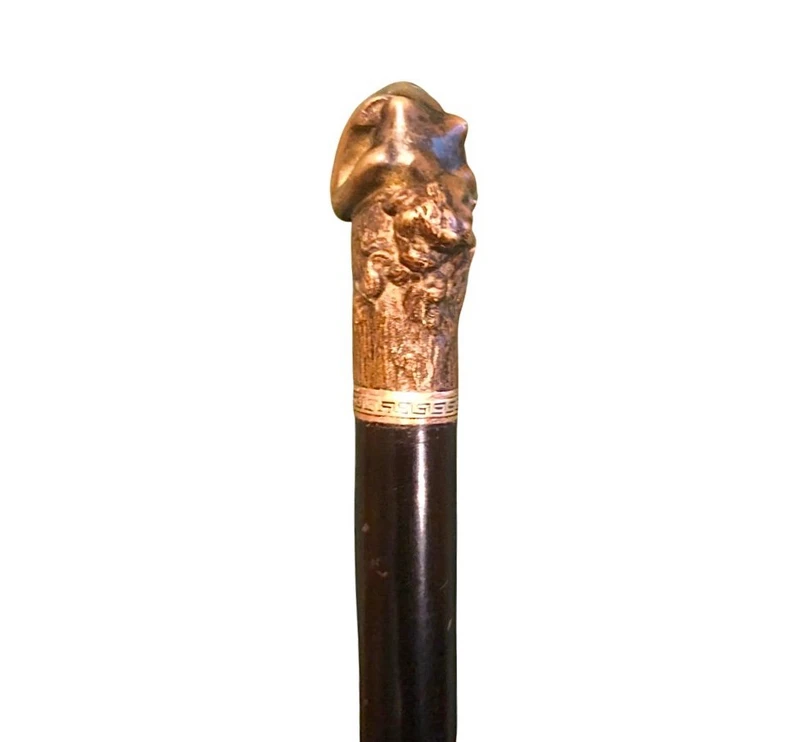 A walking stick with an erotic motif, featuring a bronze handle depicting a reclining nude woman.