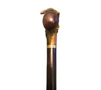 A walking stick with an erotic motif, featuring a bronze handle depicting a reclining nude woman.