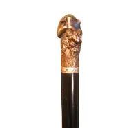 A walking stick with an erotic motif, featuring a bronze handle depicting a reclining nude woman.
