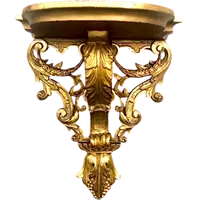 Mensola in legno e foglia oro con festoni ,volute rocaille e motivi vegetali stilizzati.