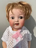 Poupée avec une tête en biscuit, des yeux mobiles et un corps en papier mâché. Signée Heuback, Allemagne.