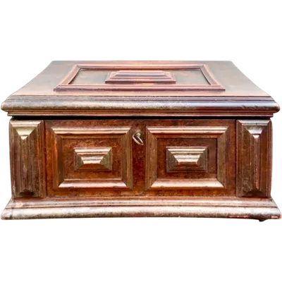 A walnut chest-shaped box with compartments and a mirror inside.