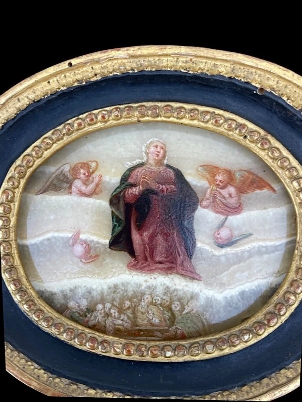 Oval alabaster painting depicting the Virgin Mary with angels and figures.