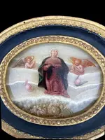 Oval alabaster painting depicting the Virgin Mary with angels and figures.