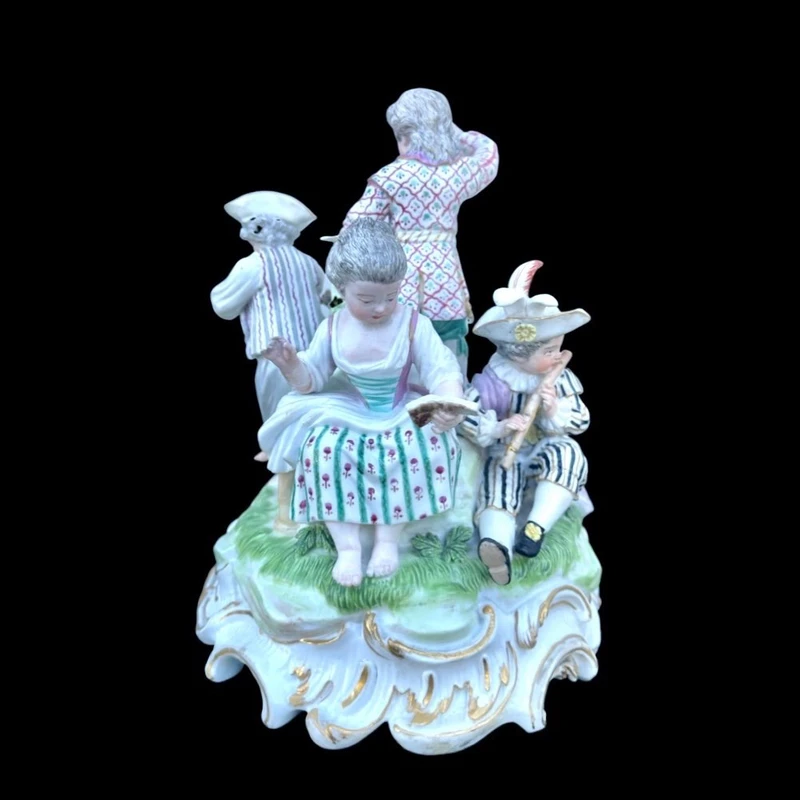 A porcelain figurine set depicting children playing musical instruments. Meissen.