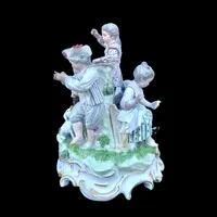 A porcelain figurine set depicting children playing musical instruments. Meissen.