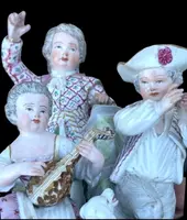 A porcelain figurine set depicting children playing musical instruments. Meissen.