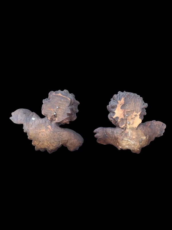 Pair of carved wooden cherubs with a marbled finish. Liguria.