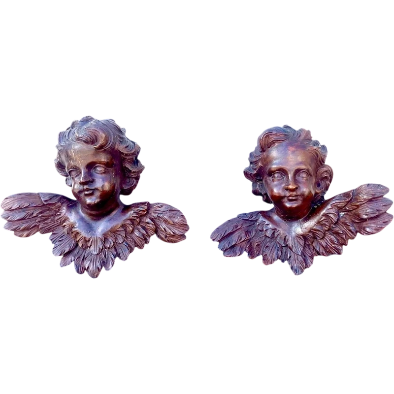 Pair of carved wooden cherubs with a marbled finish. Liguria.