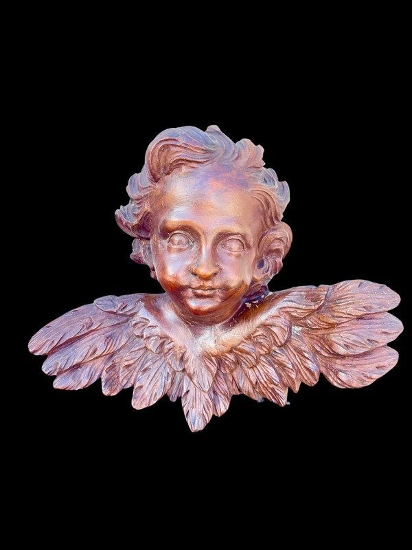 Pair of carved wooden cherubs with a marbled finish. Liguria.