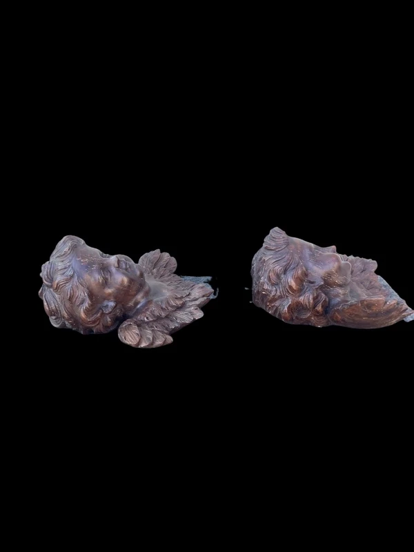 Pair of carved wooden cherubs with a marbled finish. Liguria.
